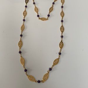 Gold tone and purple like amethyst stone